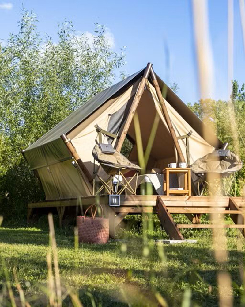 Tente bivouac avec terrasse bois et équipement de camping